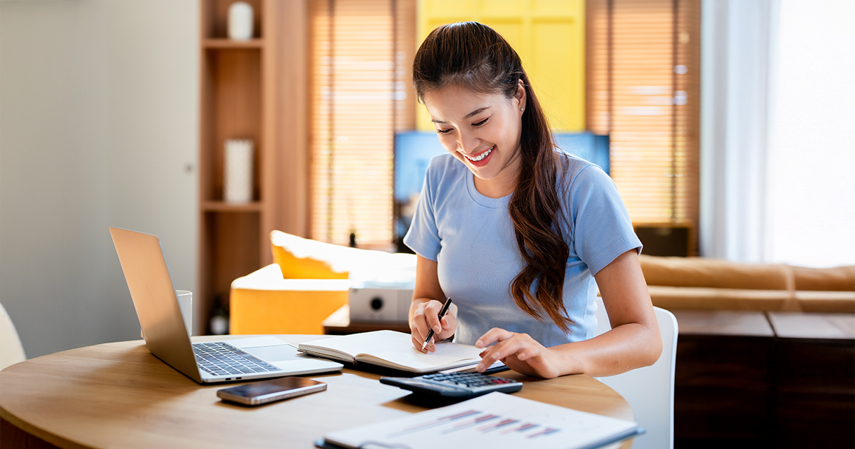 woman using calculator at desk