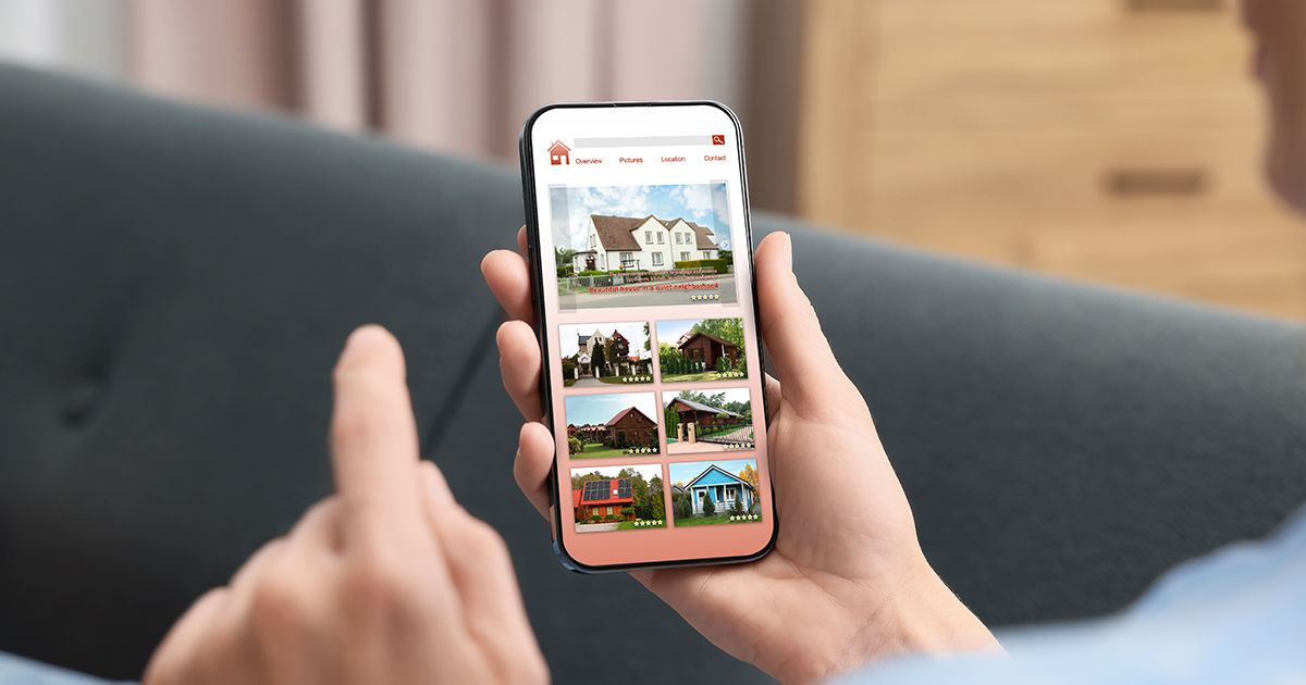 person looking at house listings on cell phone