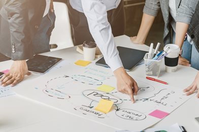 People brainstorming ideas on a paper