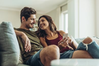 unmarried couple discussing finances on couch